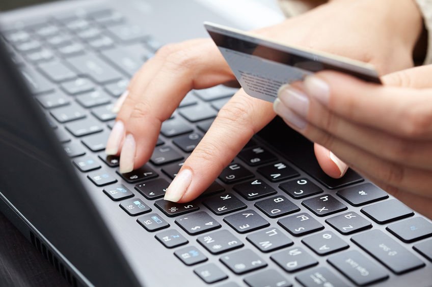 woman holding credit card on laptop for online shopping concep
