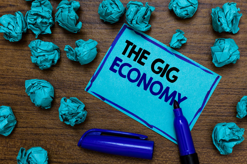 Conceptual hand writing showing The Gig Economy. Business photo showcasing Market of Short term contracts freelance work temporary written blue letters on page blue marker and paper lumps. Conceptual hand writing showing The Gig Economy. Business photo showcasing Market of Short term contracts freelance work temporary written blue letters on page blue marker and paper lumps.