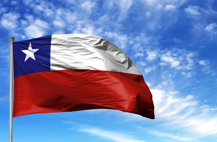 National flag of Chile on a flagpole in front of blue sky National flag of Chile on a flagpole in front of blue sky