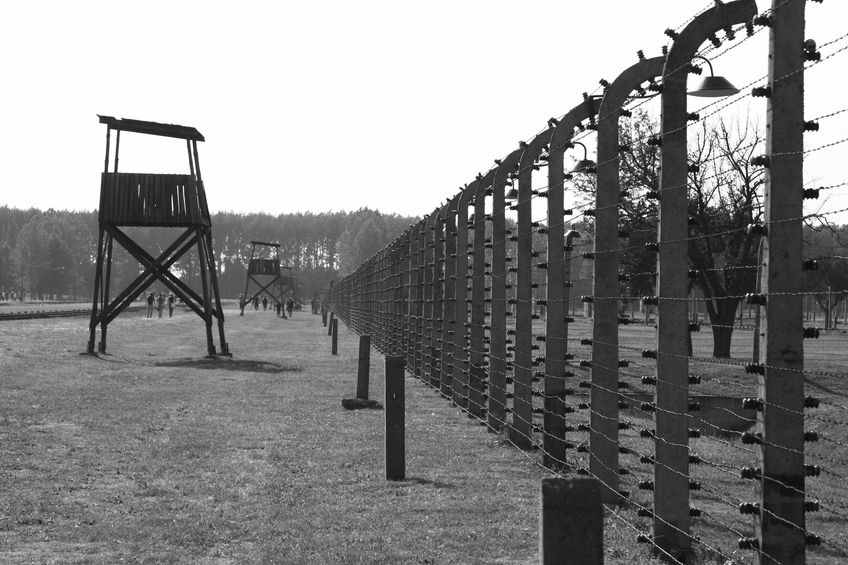 7609061 a fence and guard tower at the death camp auschwitz, poland.