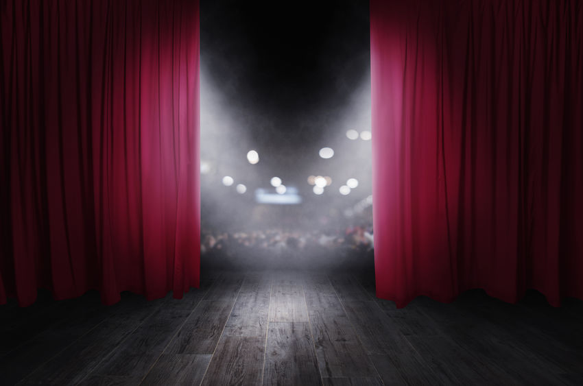 The red curtains are opening for the theater show