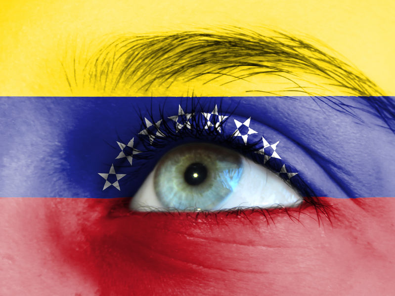 Close up view of a young girl. The flag of Venezuela is painted on the girl face. Close up view of a young girl. The flag of Venezuela is painted on the girl face.