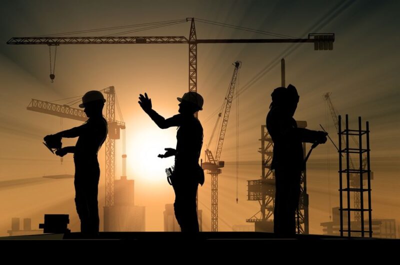 20557849 group of workers talk among themselves.