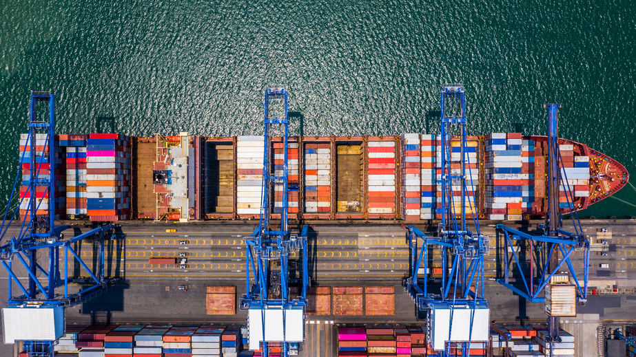 Container ship loading and unloading in deep sea port, Aerial to