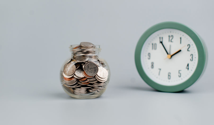 Coins and an alarm clock savings concept finance finance busines