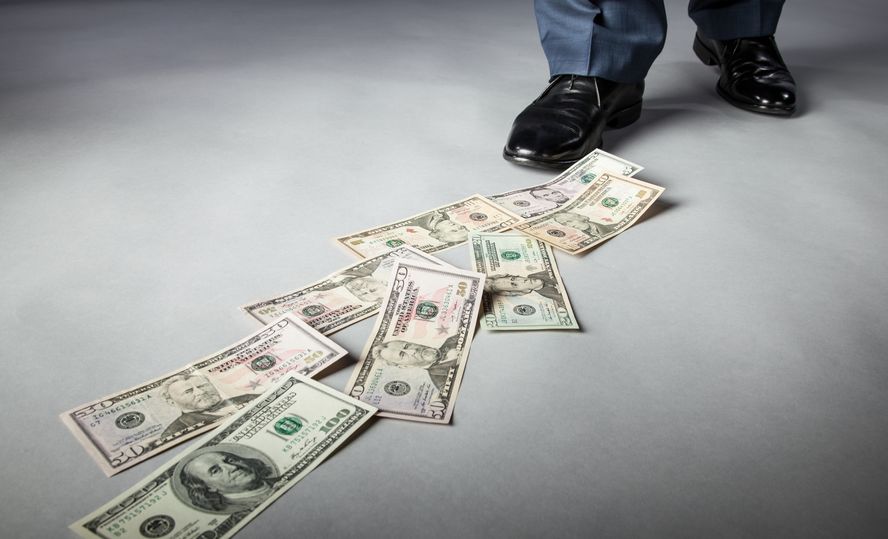 19310673 men's feet and dollar banknotes on the floor