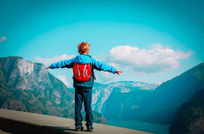 happy little boy enjoy travel in mountains, hiking in nature