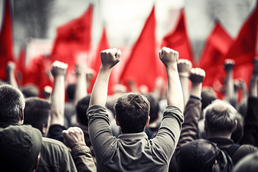 Crowd of People Raising Their Hands in the Air