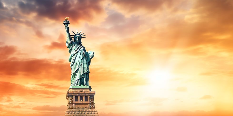 225346569 statue of liberty at sunset in new york city, usa.