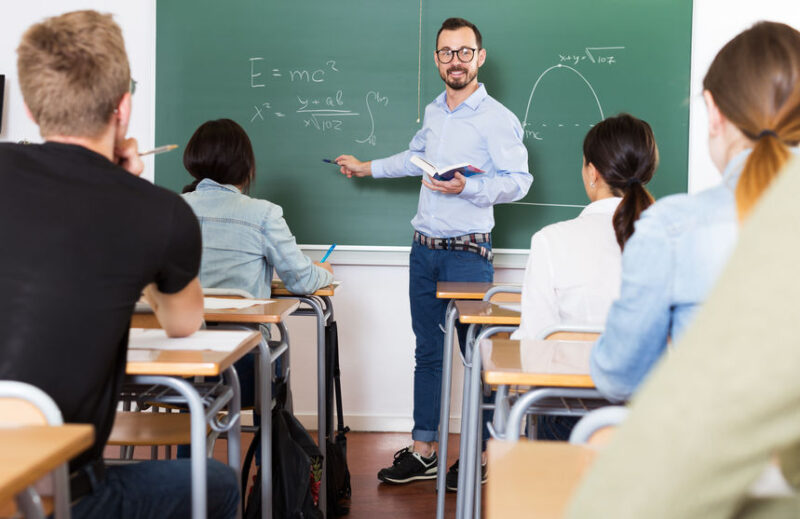 Man teacher giving lecture in classroom